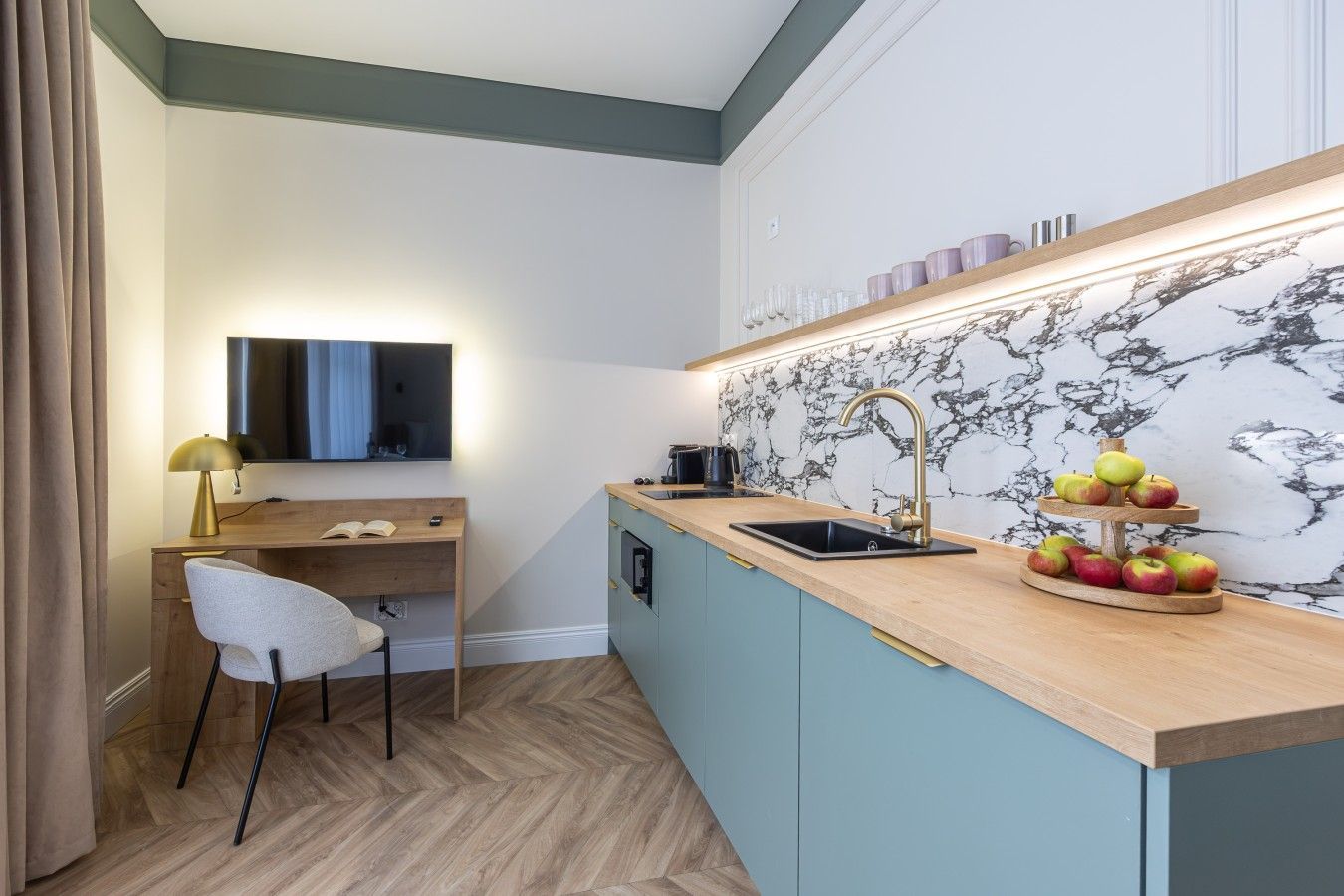 A compact kitchenette with a wooden countertop, a sink, and a marble backsplash.