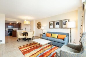 A modern living room with a sofa, coffee table, and chairs. There is a kitchen in the background. - Resort in Las Vegas. Pools, spas, Gym, National Finals Rodeo week - Adjoining AB (Las Vegas)