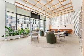 A modern interior with a wooden ceiling, large windows, and a patterned wall. - GuestReady - Modern Studio with Balcony & Pool (Vila Nova de Gaia)