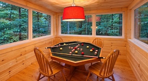 A pool table in a wooden room with large windows and a red lamp. - Bearly Behavin - Smart Cabin, Hot Tub & Fire Pit (Sevierville)
