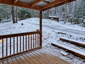 A wooden deck with a railing overlooking a snowy landscape and a road. - Bearly Behavin - Smart Cabin, Hot Tub & Fire Pit (Sevierville)