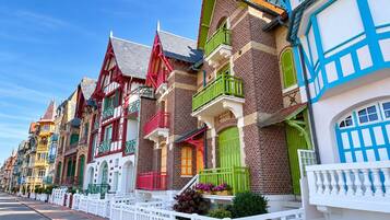 A row of colorful buildings with distinct architectural styles, including gabled roofs and decorative balconies.