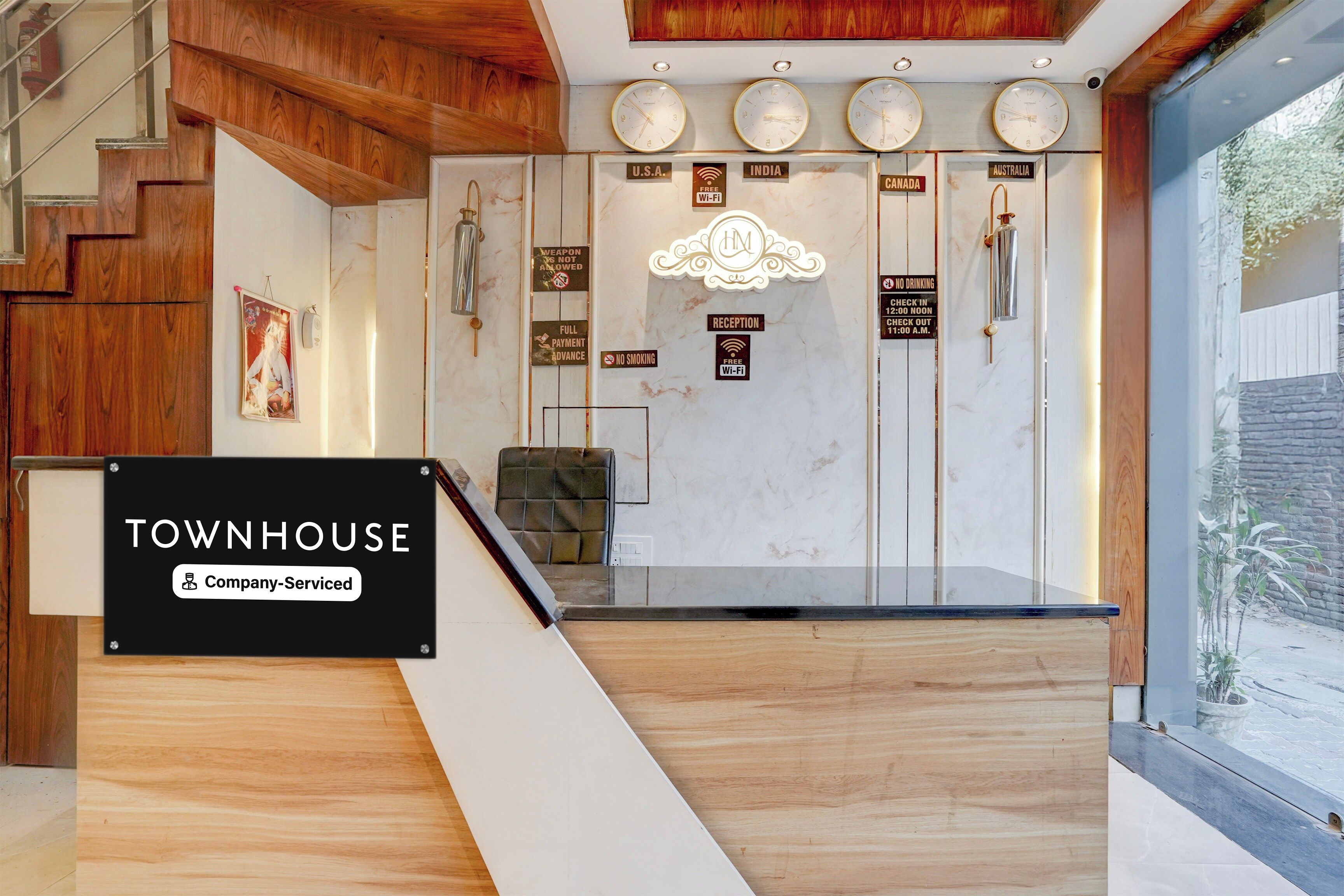 A reception desk with a sign indicating 'TOWNHOUSE Company-Serviced'.