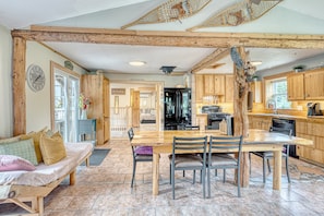 A rustic kitchen with wooden beams, a dining table, and a bench. -  Large, Treehouse cottage, sleeps 15, 10 min from Ski-Wentworth, Dog Friendly (Westchester Station)