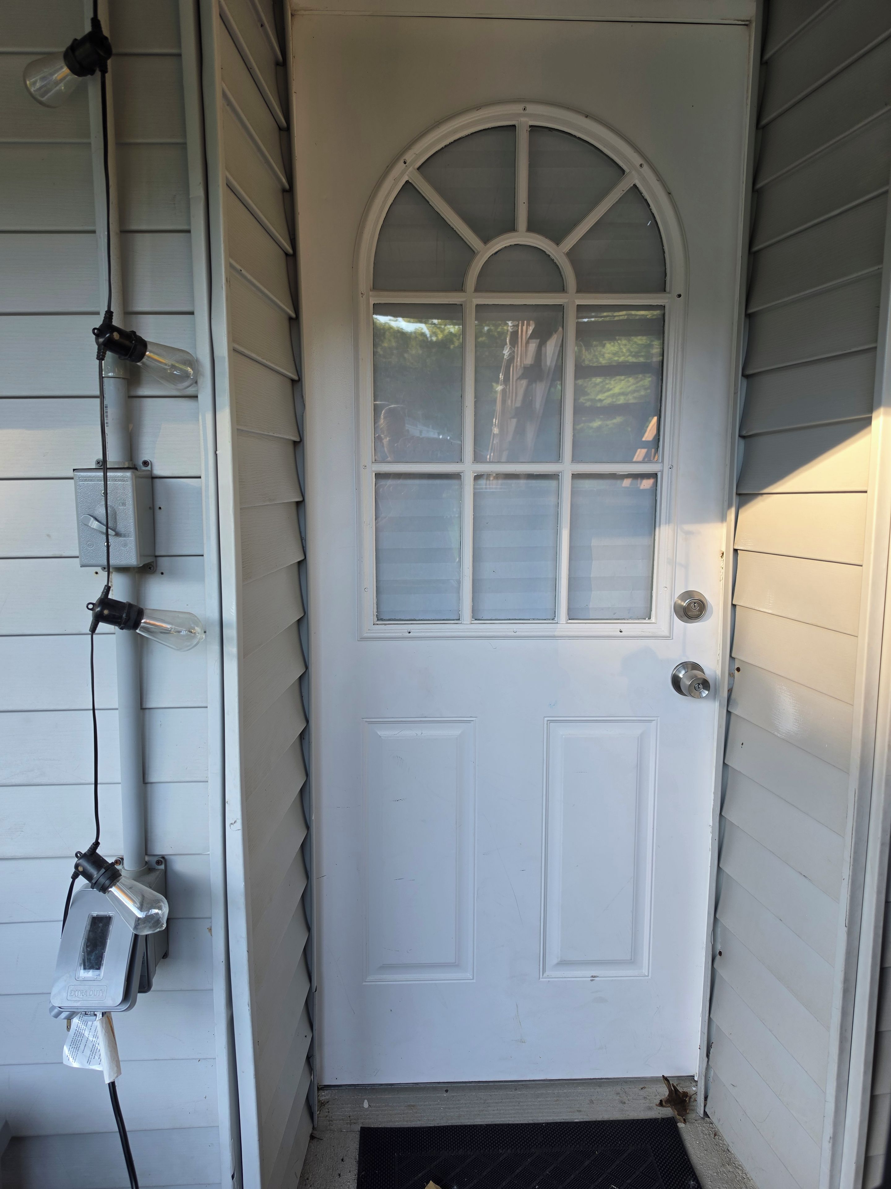A white door with a glass panel and a metal handle.