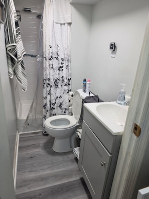 A bathroom with a toilet, sink, shower, and a towel rack. - Fabulous 1-bedroom studio in charming Norwich perfect for your stay. (Norwich)