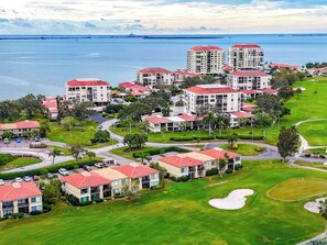 A residential area with multiple buildings, roads, and a golf course. - Relaxed Island Living Condo Golf Course Views (St.Petersburg)