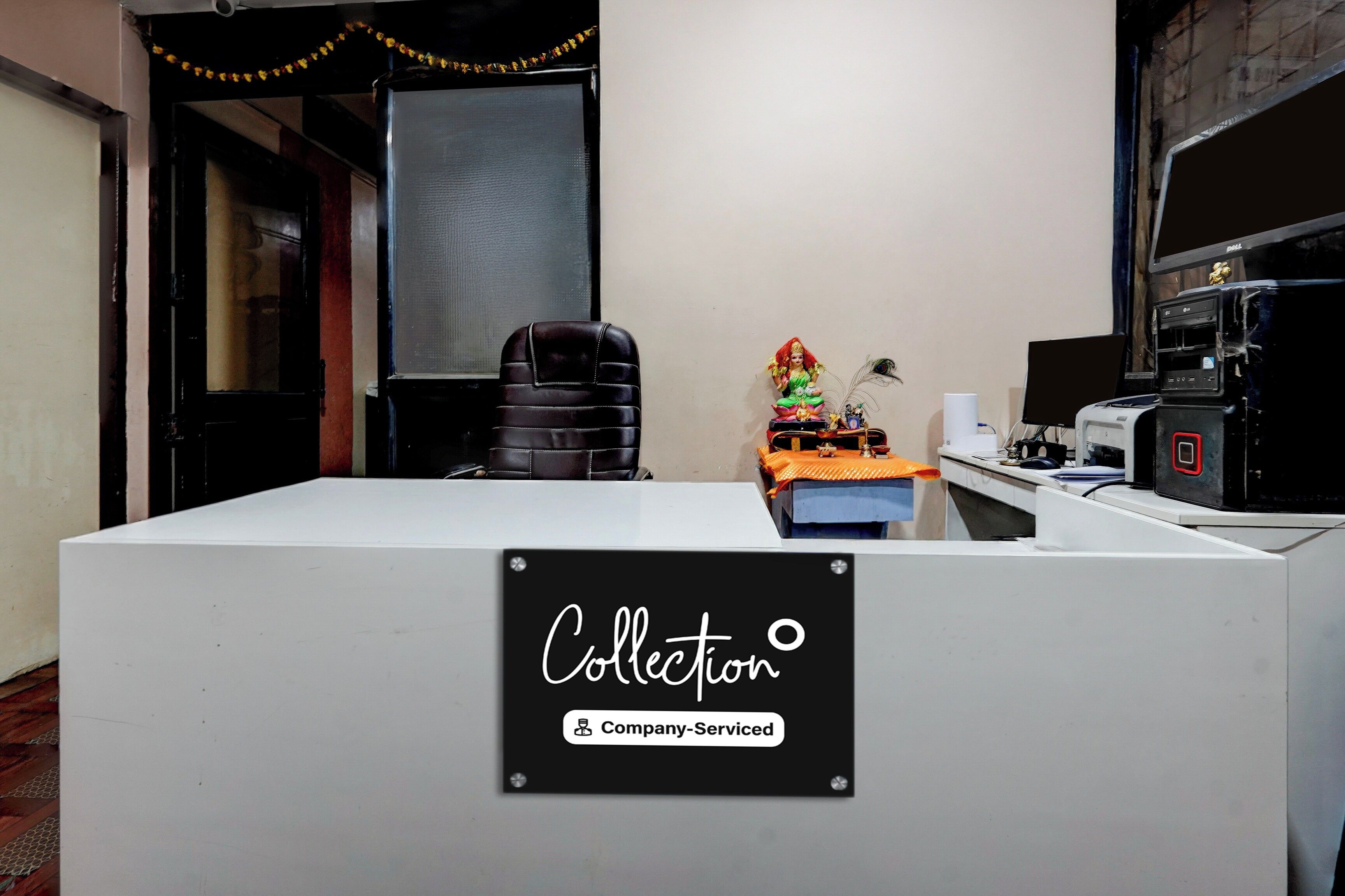 A reception desk with a sign reading 'Collector Company Serviced'.