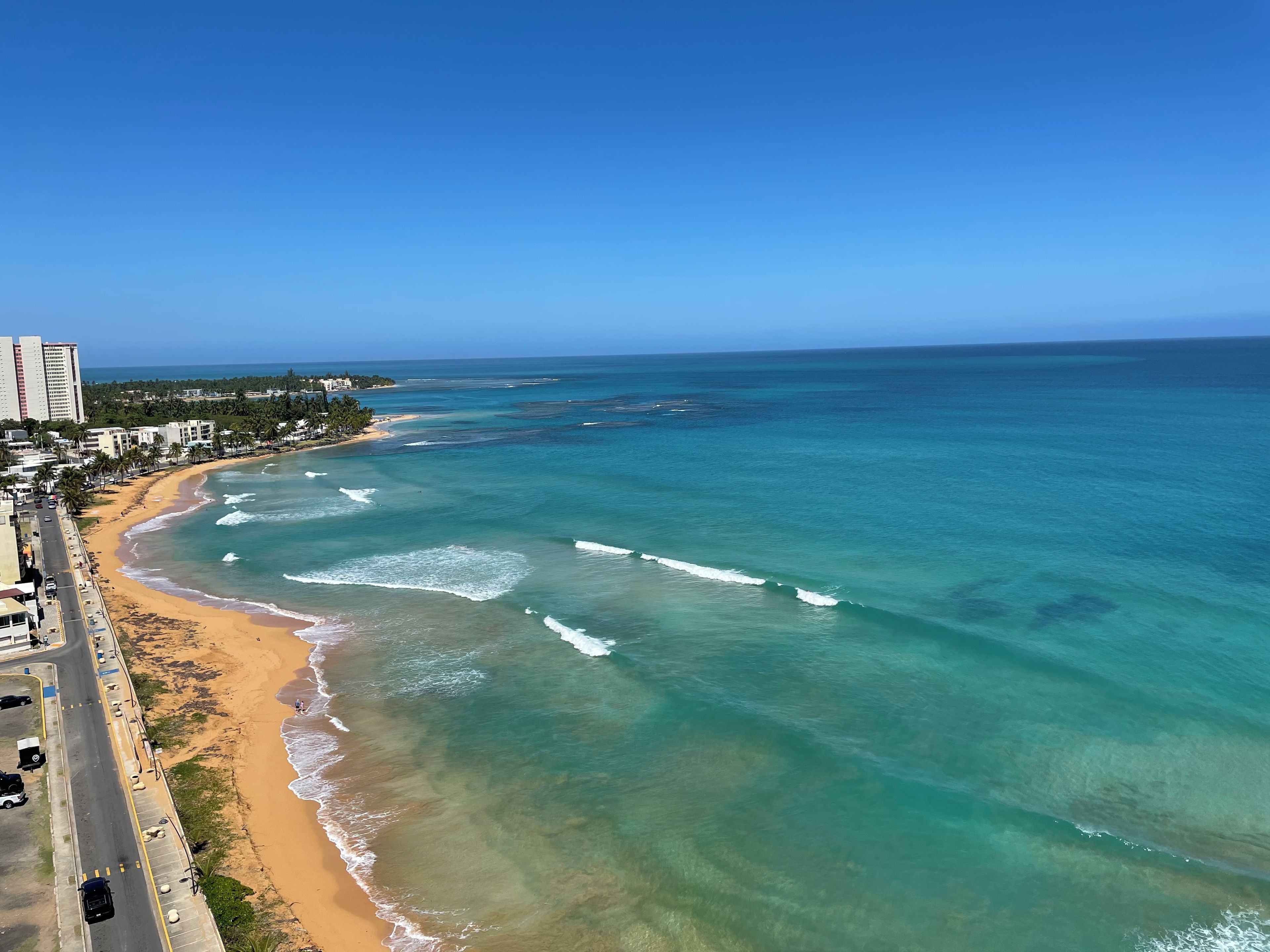 A coastal road with a beach and ocean view.