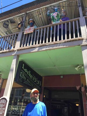 A storefront with a sign for 'Locke's BBQ' and a balcony above.