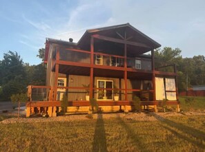 A two-story building with a balcony, large windows, and a flat roof. - White River Retreat Escape - Hot Tub, 5 BRs, 2 Homes (West Fork)