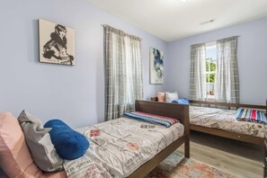 A bedroom with two beds, a mirror, a painting, and curtains. - White River Retreat Escape - Hot Tub, 5 BRs, 2 Homes (West Fork)