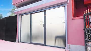 A building with a large glass door and a metal gate.