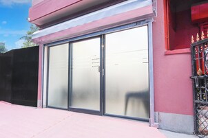 A building with a large glass door and a metal gate.
