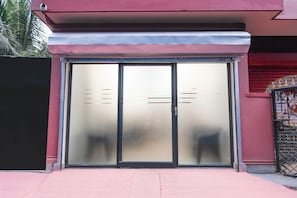 A building entrance with a glass door and a metal gate.