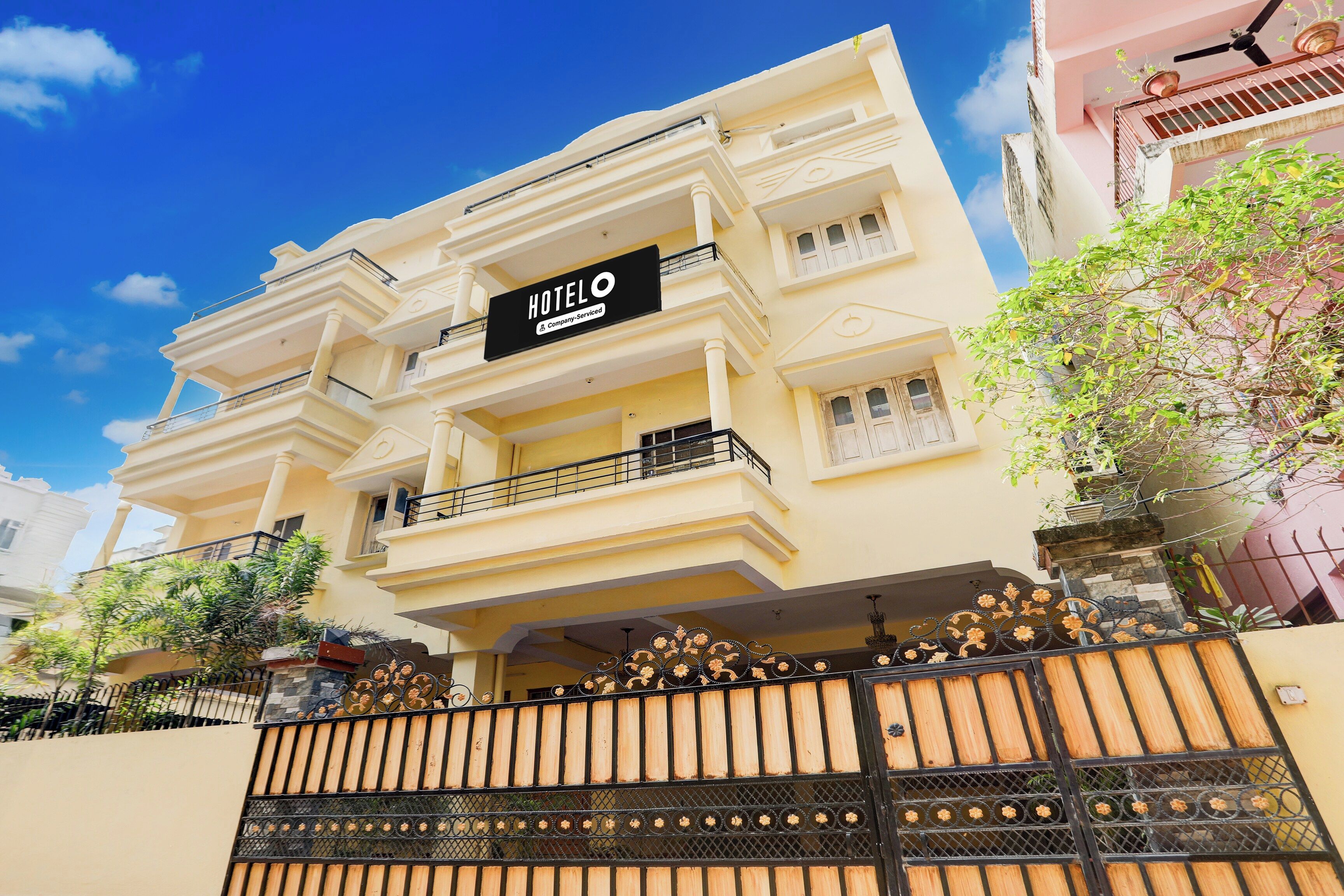 A multi-story hotel with a sign indicating it is company-serviced.