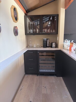 A compact kitchen with a built-in oven, a coffee maker, and a toaster. - Luxury Waterfront Villa Ocean Views and Private Dock North Vancouver (North Vancouver)