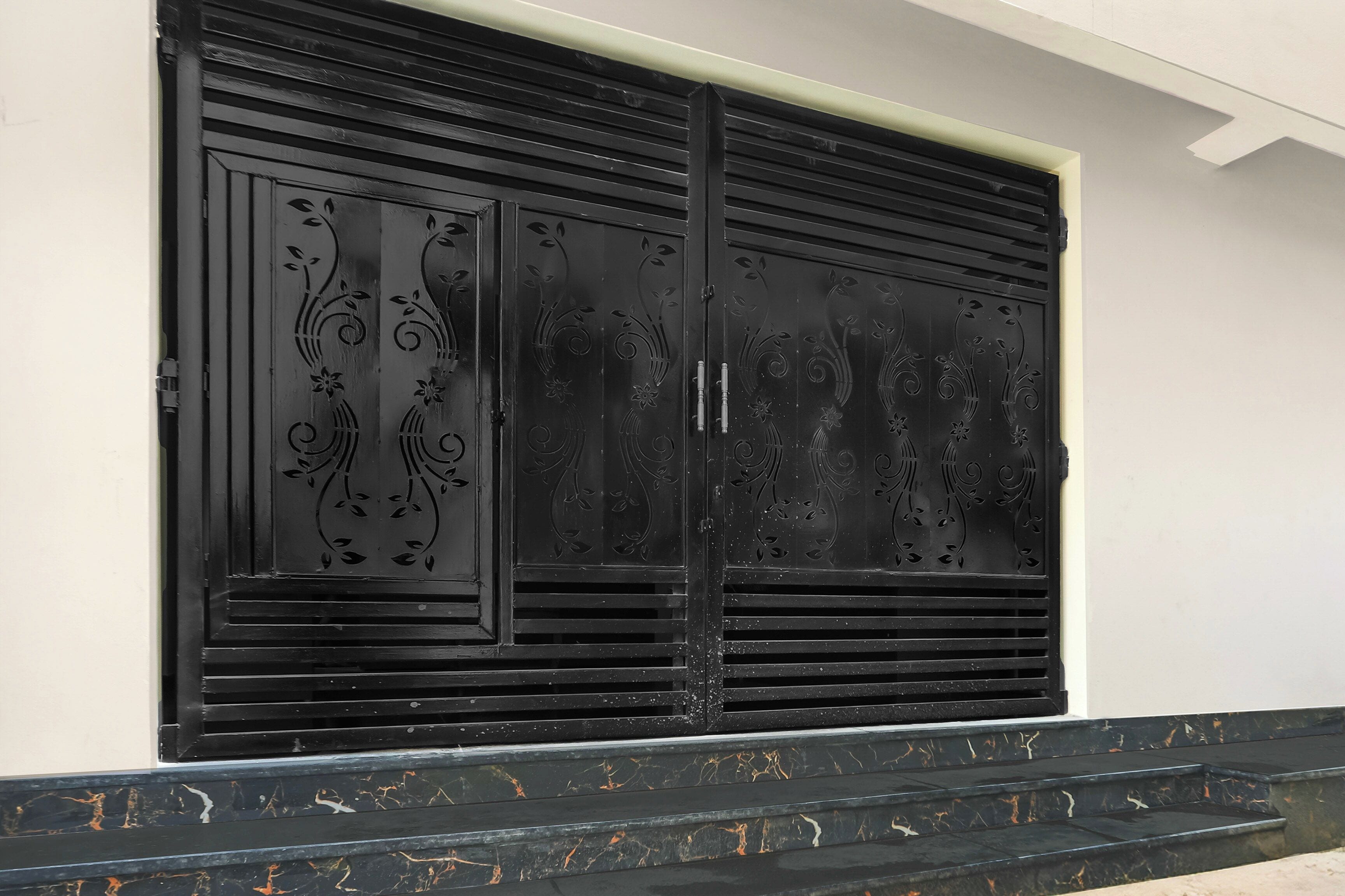 Una reixa de metall negre amb dissenys florals complexos.