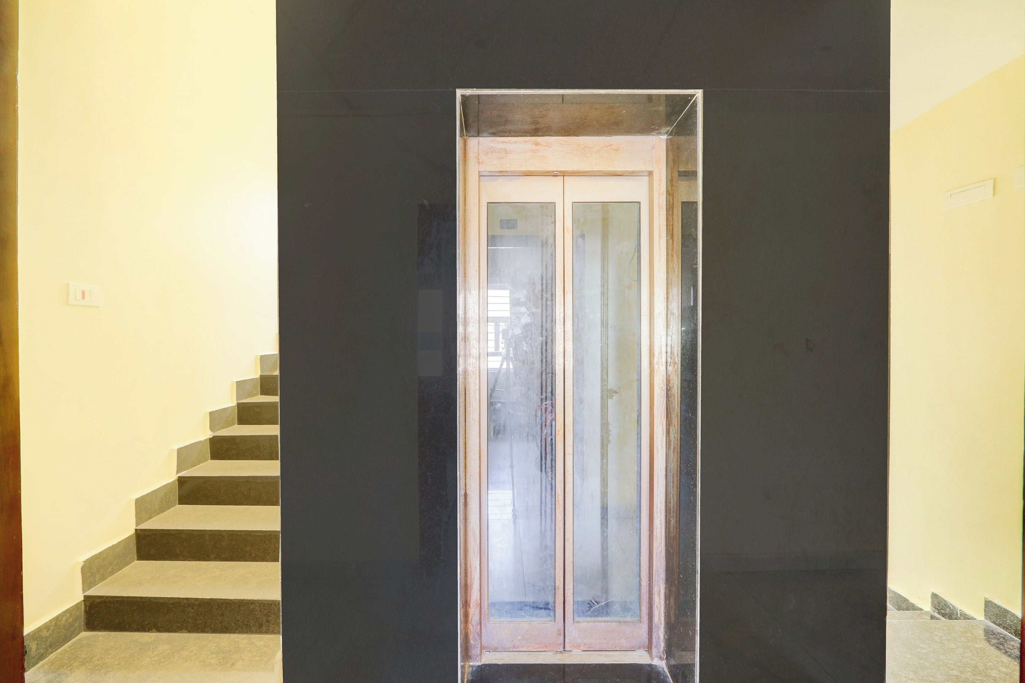 A staircase leading to a door with a glass panel.