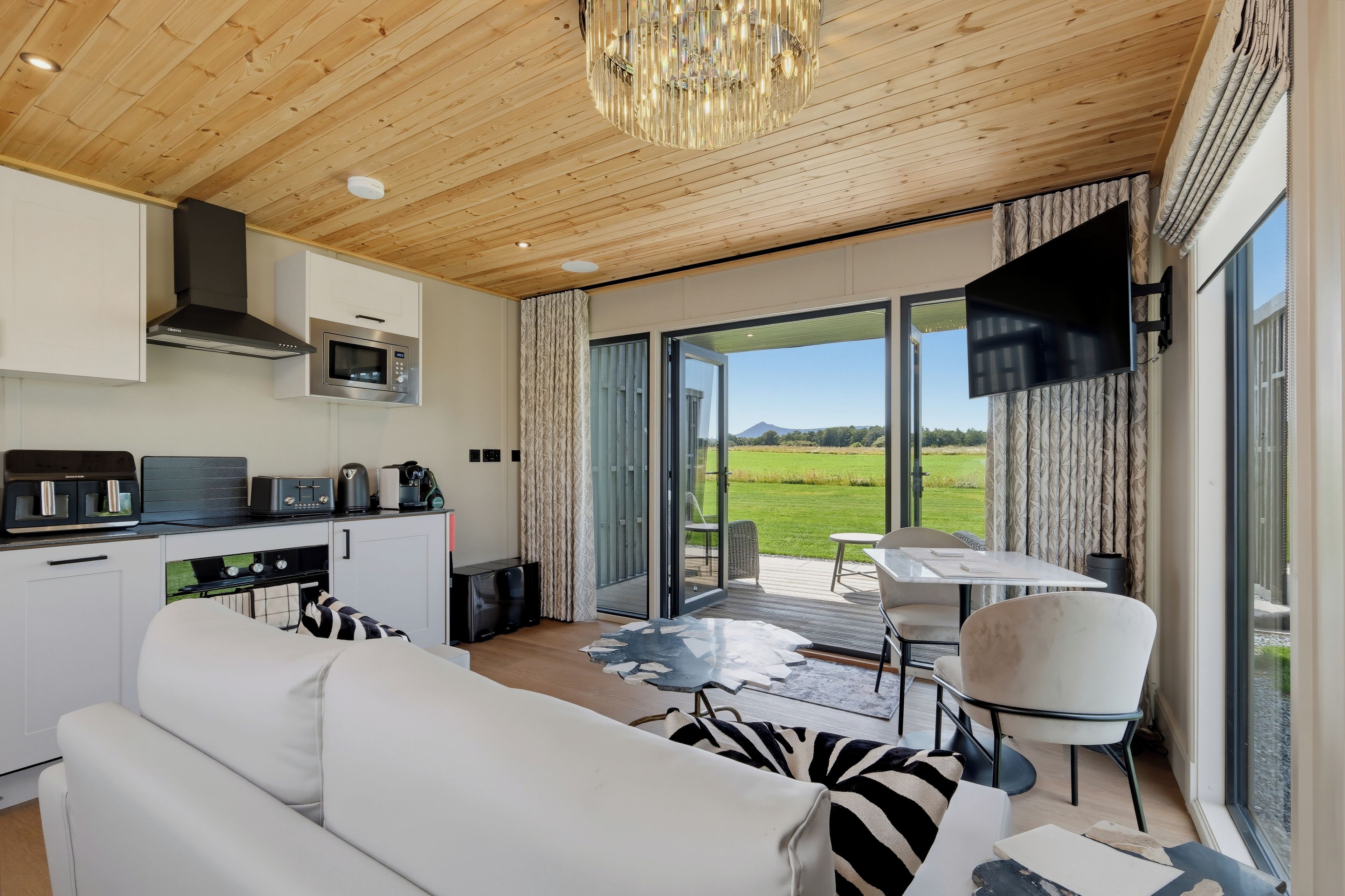 A modern kitchen with a built-in microwave, a coffee maker, and a toaster.