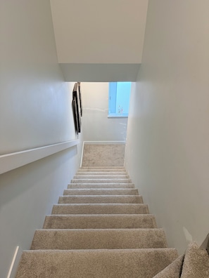 A carpeted staircase leading to a window with a view. - Ubbies place 1-Entire 4-Bed House - Private - Sleeps 8 - Regina (Regina)