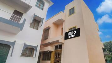 A hotel building with a sign indicating it is company-serviced.