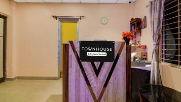 A reception area with a sign reading 'TOWNHOUSE Company Serviced'.