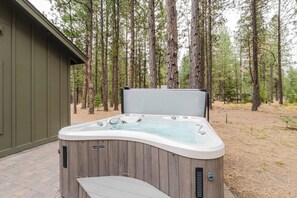 A hot tub with a wooden exterior, a bench, and a label reading 'MARCUS.' - Luxury Pines Retreat at Black Butte Ranch (Sisters)