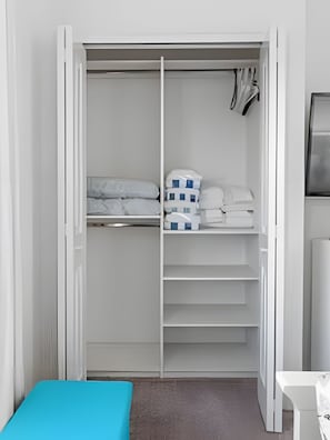 A walk-in closet with open doors, shelves, and hanging space. - 6BR Storey Lake Villa w/ Pool, Spa & EV Charger (Kissimmee)