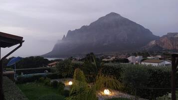 A mountainous landscape with a view of a residential area in the foreground.
