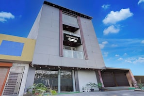 A modern building with a sign indicating it is a serviced apartment. - Townhouse Sector 67A Gurgaon (Sohna)