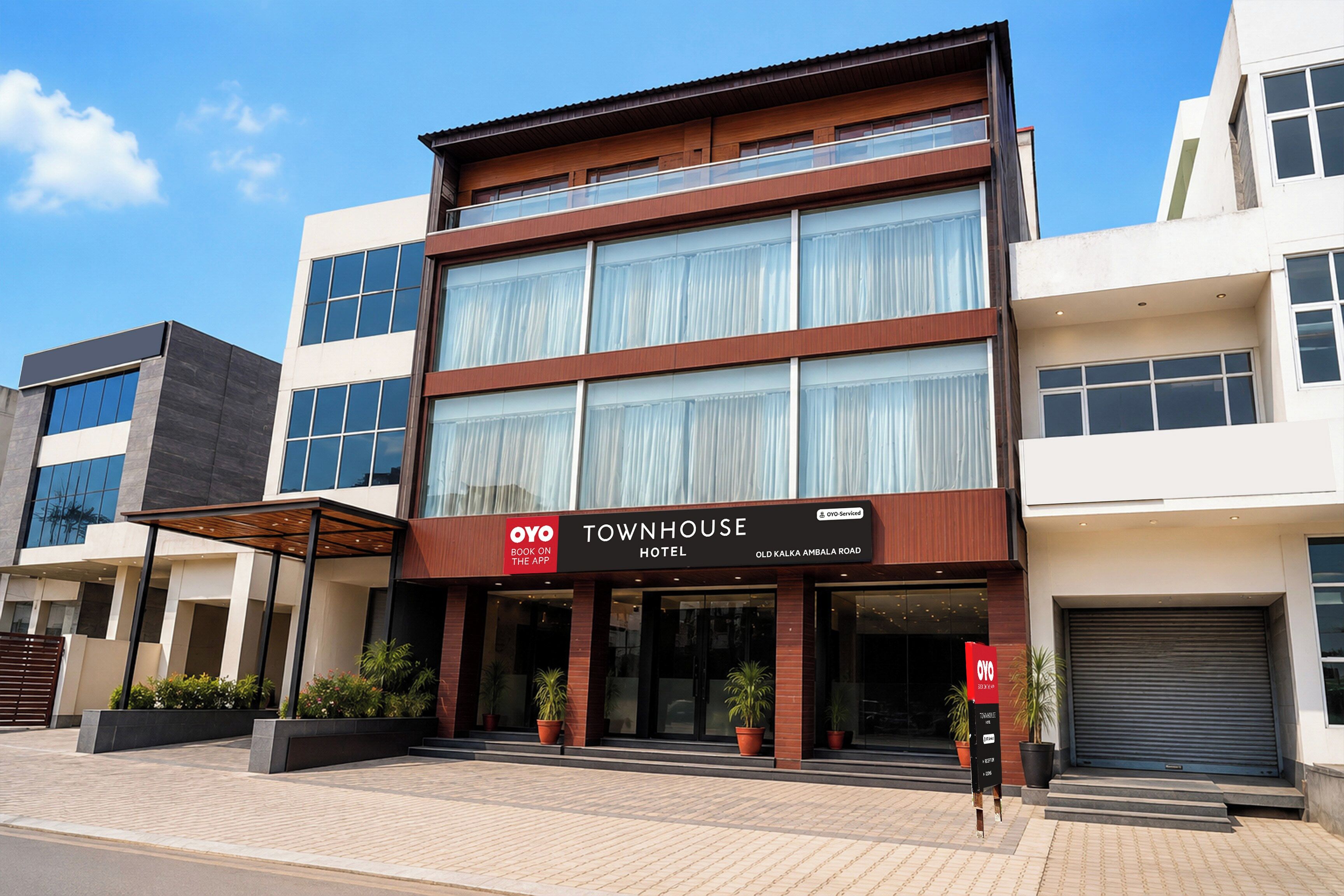 A modern hotel with a prominent sign for 'Townhouse Hotel' on the ground floor.