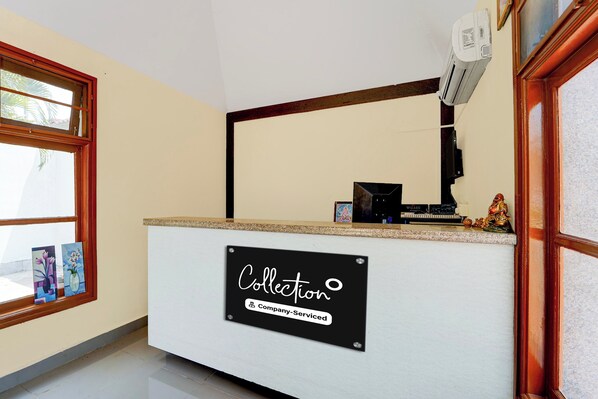A reception desk with a sign reading 'Collection Company-Serviced'.