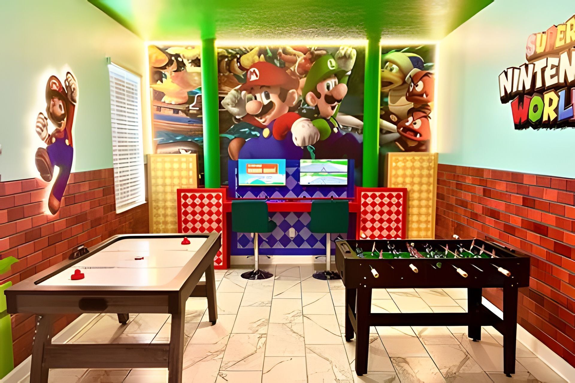 A room with a foosball table, a pool table, and a Mario-themed mural.