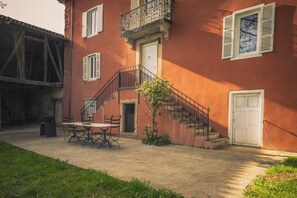 A building with a staircase, a door, and a window. - New Listing (Rouède)