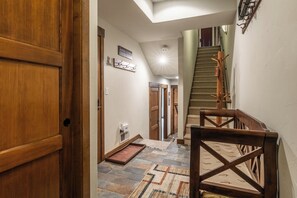 Step into your mountain retreat through this welcoming entryway, where warm wood tones and thoughtful touches set the stage for your alpine getaway. - Private Hot Tub | On Golf Course (Mammoth Lakes)