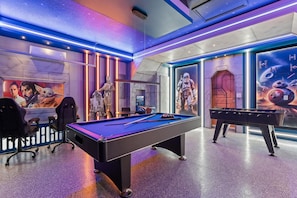 A pool table with surrounding gaming chairs, a foosball table, and Star Wars-themed decorations. - Luxury 5BR Villa With Pool and Themed Bedrooms (Clermont)