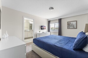 A bedroom with a bed, a desk, a dresser, a TV, and a window with curtains. - 5br/4ba Villa Sleeps 12 Private Pool & Spa (Kissimmee)