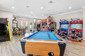 A pool table in a room with arcade games and a statue. - Vista Cay 3BR Townhome w/ Resort Access (Orlando)