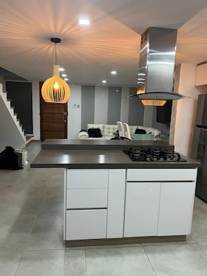 A modern kitchen with a central island, stainless steel appliances, and pendant lighting. - New Listing (Dosquebradas)