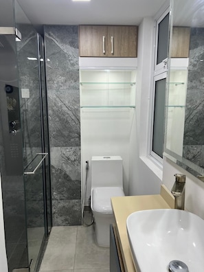 A modern bathroom with a glass-enclosed shower, a toilet, and a vanity with a sink. - New Listing (Dosquebradas)