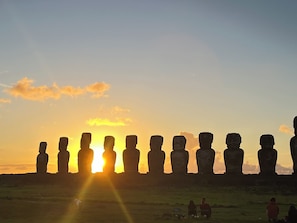 A row of stone statues at sunset. - Hare Tupuna O Piri Nui (Hanga Roa)