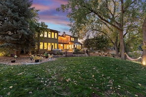 A two-story house with a well-maintained lawn and a hammock. - Heron Pond: Lakeside 5BR, Hot Tub+Billiards (Broomfield)