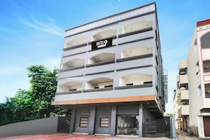 A multi-story hotel building with a sign indicating it is a hotel.