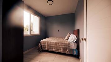 A bedroom with a bed, a window, and a door.