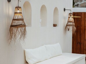 A bed with white bedding in a room with white walls and wooden paneling. - Lodge with private pool, nature - 4 guests (Salazie)
