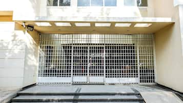 Una entrada cerrada con un portón de metal y escalones que conducen a un edificio.