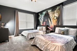 A bedroom with two beds, a large wall mural, and a desk with a lamp. - 5-bedroom House in Championsgate With Private Pool (Kissimmee)