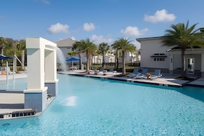 A swimming pool with lounge chairs and a water feature. - 9br/9.5ba - 20 Guests Luxury Villa Sonoma Resort (Kissimmee)