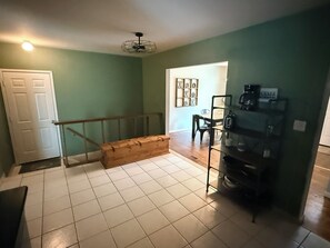 A room with a staircase, a coffee machine, and a door. - Charming Vintage Home On A Quiet St (Sterling Heights)